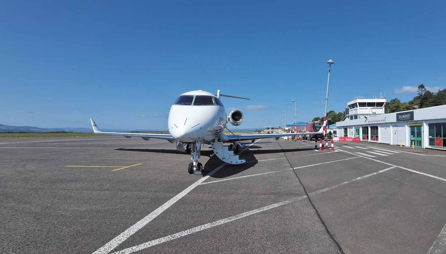 LN-JHH stopped on the apron facing the camera, with its left wingtip against a red and white lamppost in front of the terminal building.